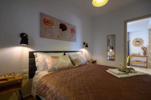 a bedroom with a large bed and a mirror at Chic Apartment in Nature, 5-min walk to the Beach in Kalamata