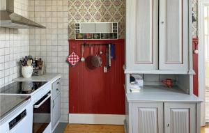 a kitchen with a red door in the corner at Gorgeous Home In Lindesberg in Lindesberg