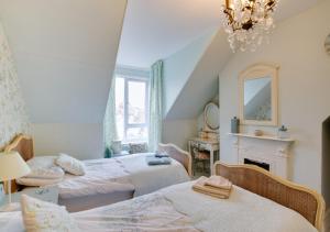 a bedroom with two beds and a fireplace at Upper Nestleton Maisonette in Swanage