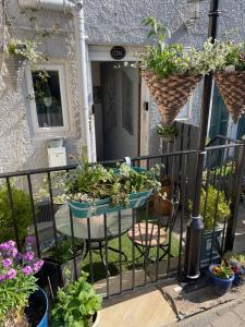 a balcony with potted plants on a house at Pennine View - Manchester: Rochdale Littleborough in Littleborough