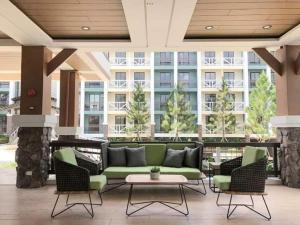 a lobby with a couch and chairs and a building at Pine Suites By Crown Asia Family Staycation in Tagaytay