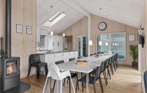 a kitchen and dining room with a table and a fireplace at Beautiful Home In Ålbæk With Kitchen in Ålbæk