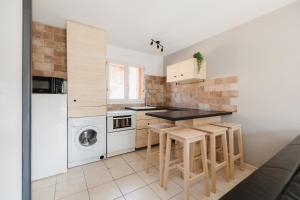 une petite cuisine avec lave-linge et sèche-linge dans l'établissement Charmante maison contemporaine idéalement située, à Embrun