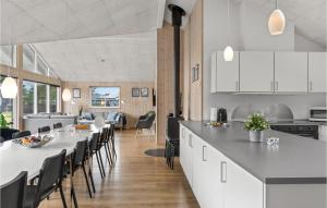 a kitchen and dining room with white tables and chairs at Beautiful Home In lbk With Kitchen in Ålbæk