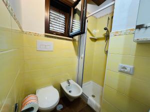 a small bathroom with a toilet and a sink at Villetta Starza in Marina di Camerota