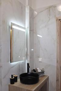 a bathroom with a black sink and a mirror at Meteora's unique gem in Kastrákion
