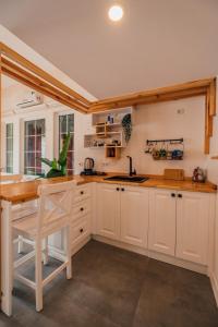 a kitchen with white cabinets and a wooden counter top at Latte Villas in Sapanca