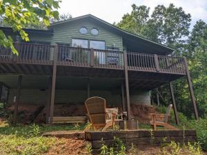 a house with a deck with chairs on it at Love Nest in Blue Ridge in Blue Ridge