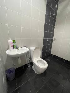 a bathroom with a toilet and a sink at 4 Bedroom SeaView Ladang Tanjung Apartment - Ayla Homestay in Kuala Terengganu