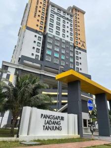 a large building with a sign in front of it at 4 Bedroom SeaView Ladang Tanjung Apartment - Ayla Homestay in Kuala Terengganu