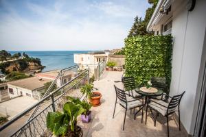 a balcony with a table and chairs and the ocean at Apartments Jelena Ulcinj in Ulcinj