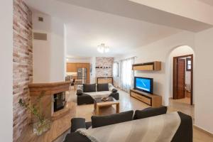 a living room with a couch and a fireplace at Dream Inn Paros, private pool in Sarakíniko