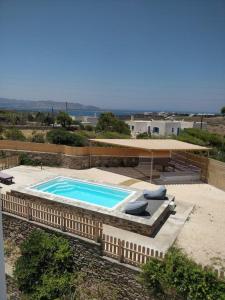 a swimming pool with loungers next to a building at Dream Inn Paros, private pool in Sarakíniko