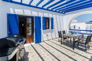 a patio with a table and chairs and a grill at Dream Inn Paros, private pool in Sarakíniko