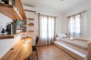 a bedroom with a bed and a desk and a table at Dream Inn Paros, private pool in Sarakíniko +50 photos