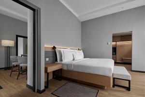 a hotel room with a bed and a desk and a bedroom at AC Hotel by Marriott Penang in Bayan Lepas