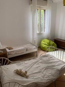 een kamer met 2 bedden in een kamer met een raam bij Grazioso appartamento -14 km dalla FERRARI in Serramazzoni