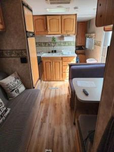 a living room and kitchen of an rv at Lakeshore Glamping Camping 239 in Portage +27 photos