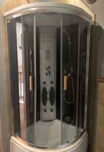 a shower in a bathroom with a glass enclosure at Pokoje Sunshine World Suites in Zakopane