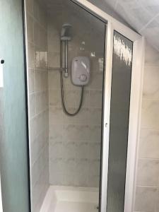 a shower with a glass door in a bathroom at Rosie's Pad in Mayo