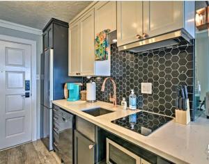 a kitchen with a sink and a counter top at Beachfront Islander East Studio in Galveston