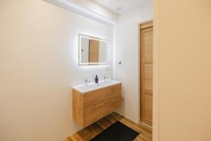 a bathroom with a sink and a mirror at Charmant T3 en Centre Ville #1 in Embrun +14 photos