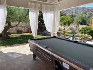 a pool table in a patio with a view at Newcastle Studios by Estia in Malia