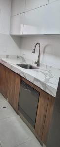 a kitchen counter with a sink and a microwave at San Martin Apartment Miraflores in Lima