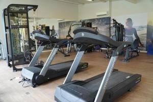 a gym with several tread machines in a room at Livyd Angra dos Reis in Angra dos Reis