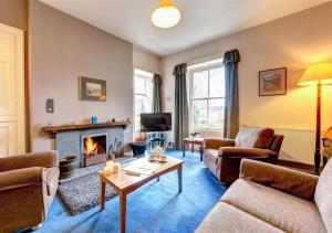 a living room with a couch and a fireplace at Ellers Close in Grasmere