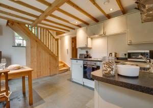a large kitchen with wooden ceilings and a counter top at The Chapel in Silecroft