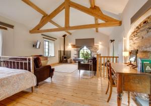 a bedroom with a bed and a desk in a room at The Chapel in Silecroft