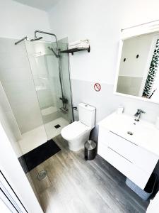 a bathroom with a toilet and a glass shower at Casa La Laja in San Juan de la Rambla