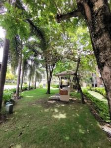 a park with palm trees and a gazebo at Davao 2br One Oasis Beside SM Mall-Wifi in Davao City
