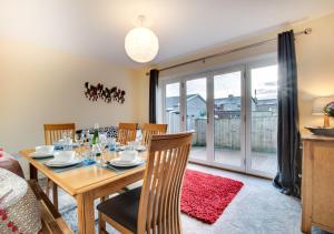 a dining room with a table and chairs and a sliding glass door at Stanhope in Ulverston