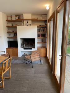 a living room with a fireplace and a chair at Casa Vacanza 2 Mari in Alghero