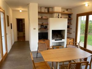 a living room with a table and a fireplace at Casa Vacanza 2 Mari in Alghero