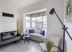 a living room with a couch and a window at Blue Alle Alaçatı in Alaçatı