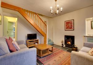 a living room with two couches and a fireplace at Tabithas Cottage in Chapel Stile