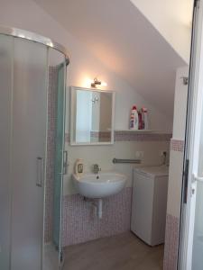 a bathroom with a sink and a mirror and a shower at Da Raff house in Lacco Ameno +7 photos