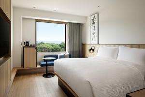 a hotel room with a bed and a window at Fairfield by Marriott Mie Kumano Kodo Mihama in Mihama