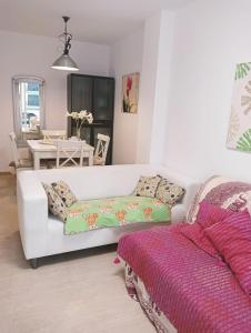 a living room with a white couch and a table at Apartamentos Playa de Moncofa in Moncófar