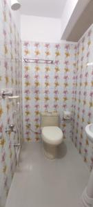 a bathroom with a toilet and a sink at Hotel Prime Inn Mirpur 10 in Dhaka