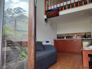 a living room with a couch and a window at T&M Timeless memories in Kazbegi