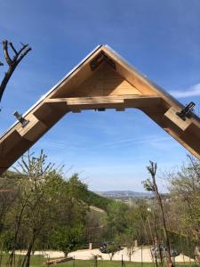 a large wooden structure with the sky in the background at StarsBox CasaSilvana in Alba
