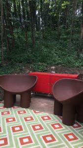 a pair of benches and a table and a red dresser at StarsBox CasaSilvana in Alba