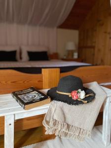 a hat sitting on a table next to a bed at Kuca Ribarev san in Beočin