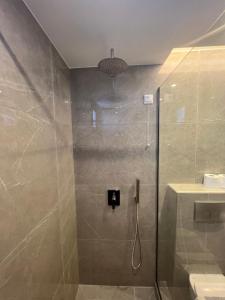 a bathroom with a shower with a glass door at Kymata Hotel in Platamonas