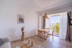 a living room with a table and a window at Grand Studio 38m2 vue Mer et Parking ! in Hyères