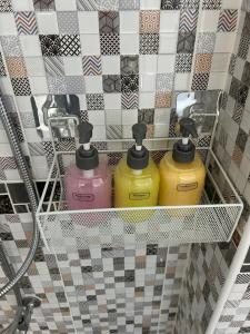 a shelf with four detergents in a bathroom at เชียงใหม่ บ้านสันติสุข in Ban Ku Sua